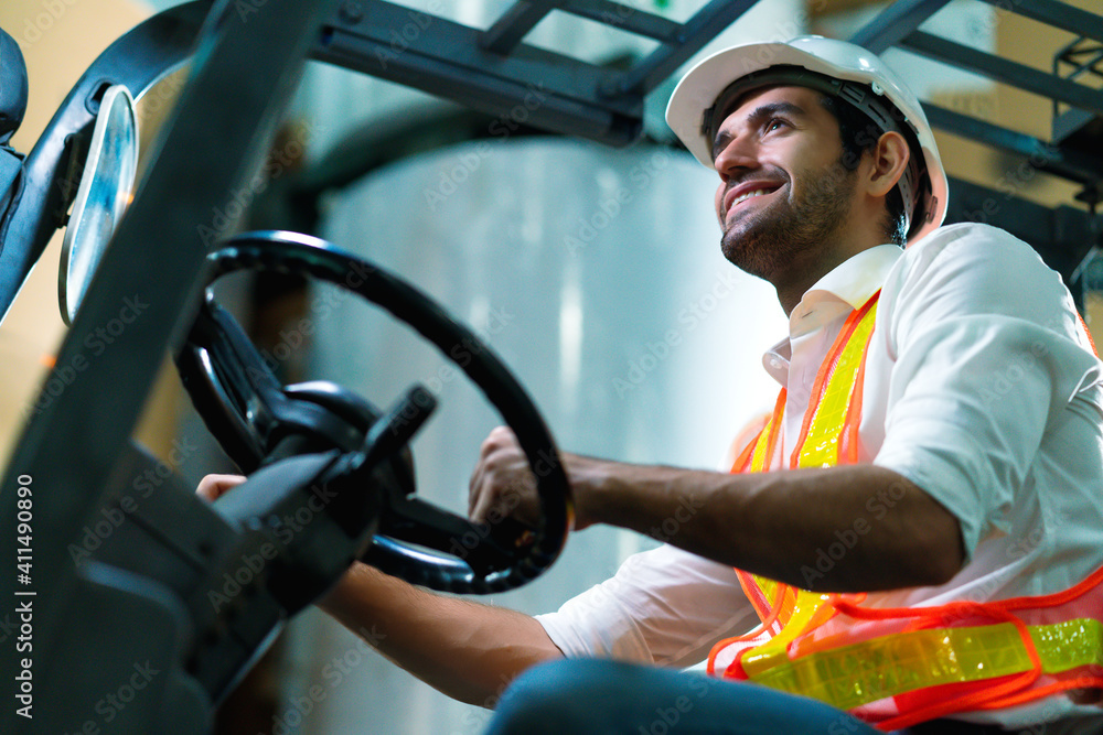 engineer staff male warehouse worker in hard hat working. walking through logistics center warehouse