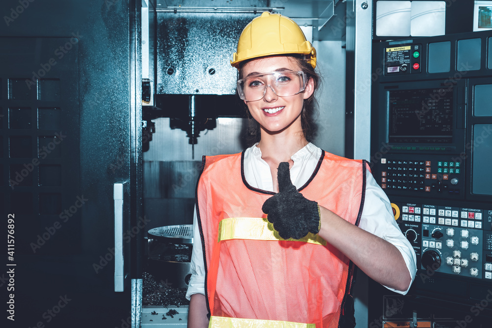 Young woman factory worker close up portrait in manufacturing job factory . Industry and engineering