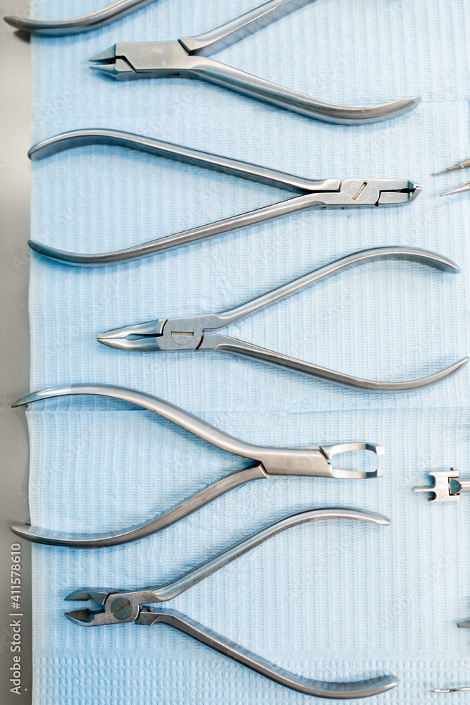 Dental tools for the orthodontic treatment lying on the table at the dental office, close-up. High q