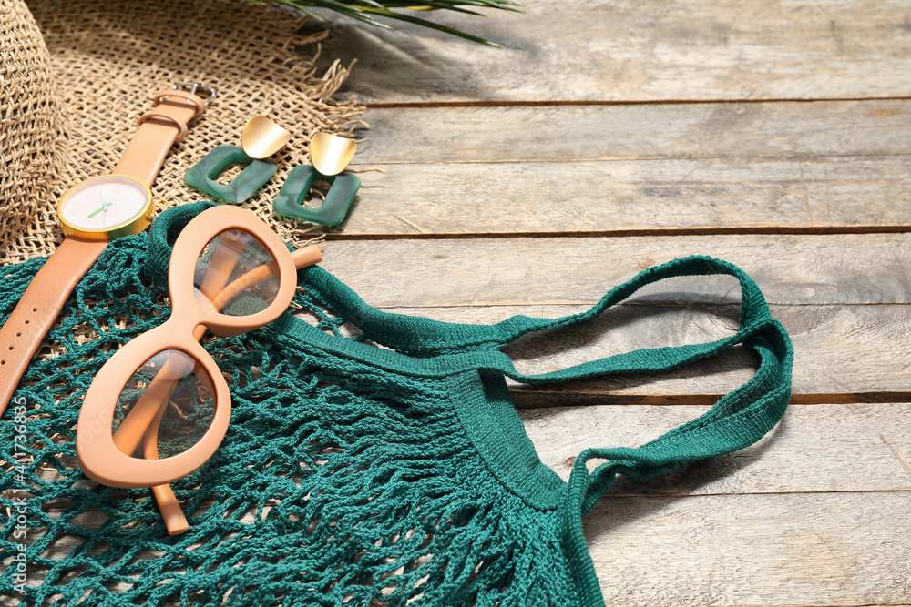 Set of female accessories and sunglasses on wooden background