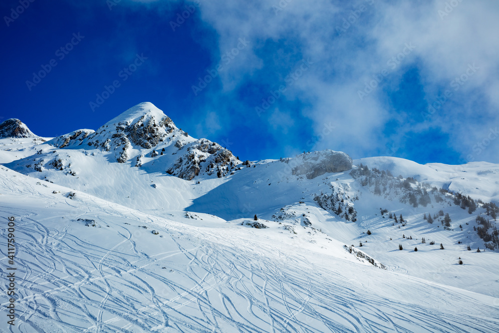 High mountain view and clouds of French Alps tops covered with snow in Les Arcs region