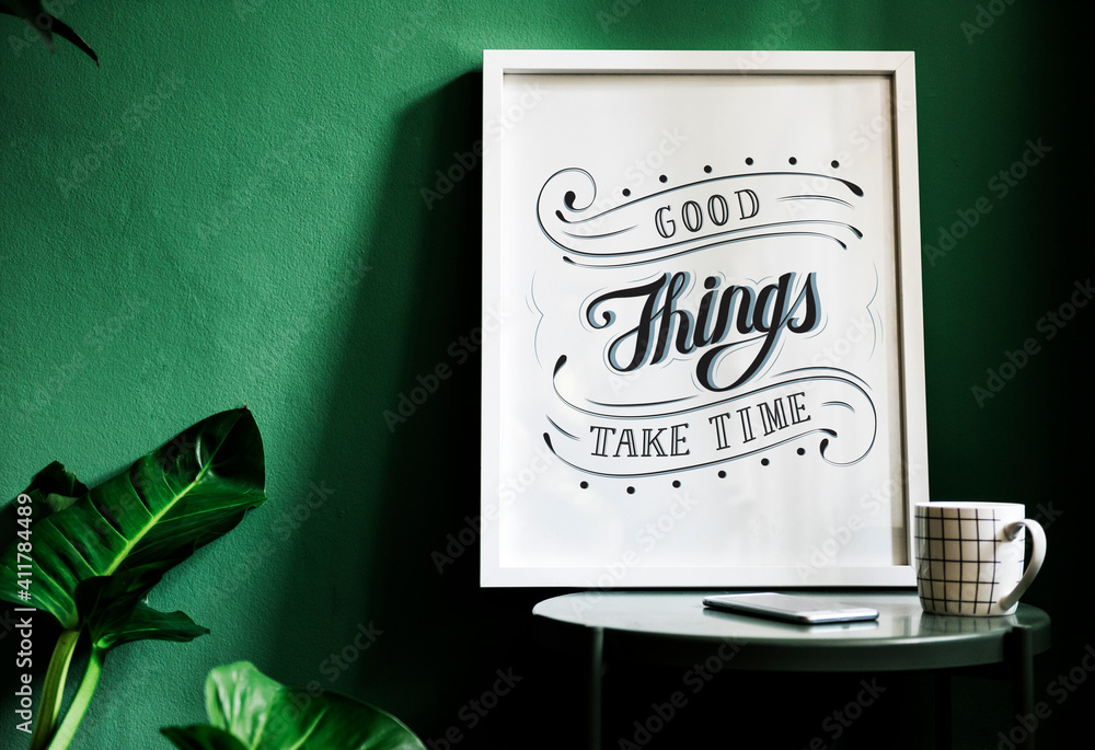 A motivation typography print on the desk against the green wall