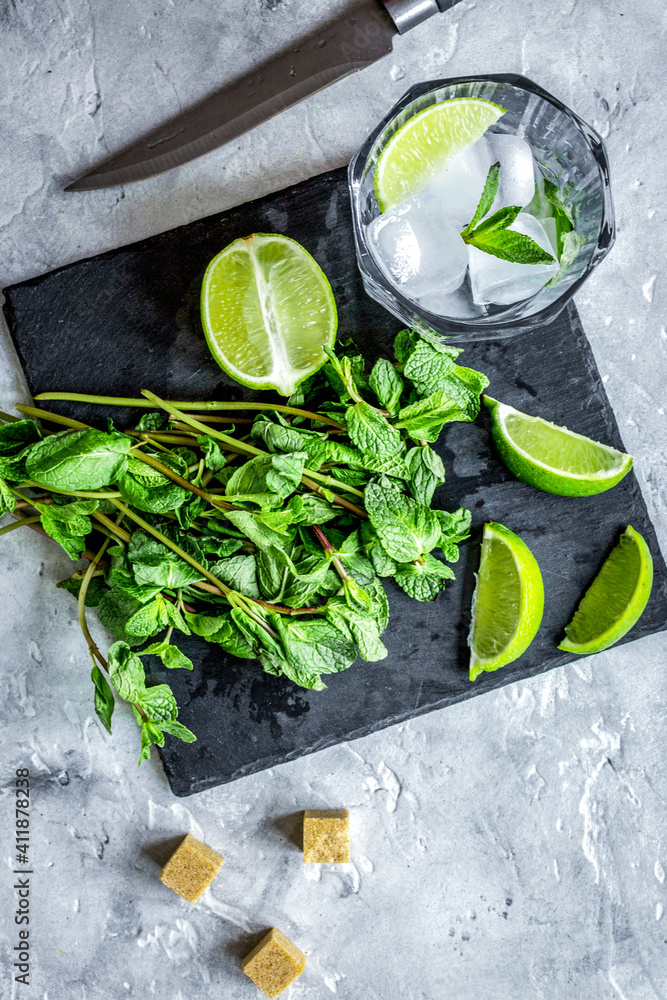 making mojito on stone background top view