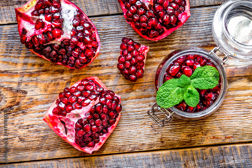 sliced pomegranate on wooden background top view