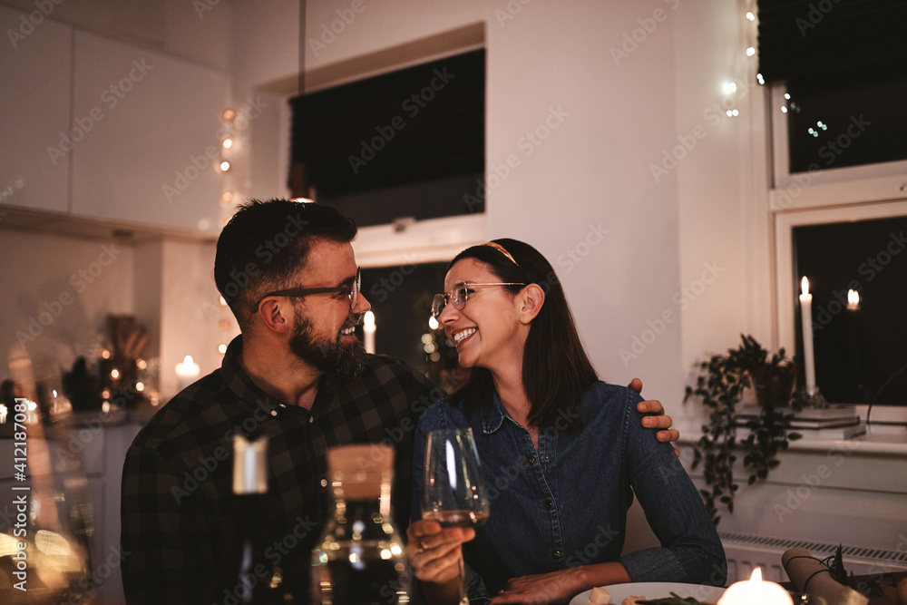 Smiling couple sitting at a table during a dinner party