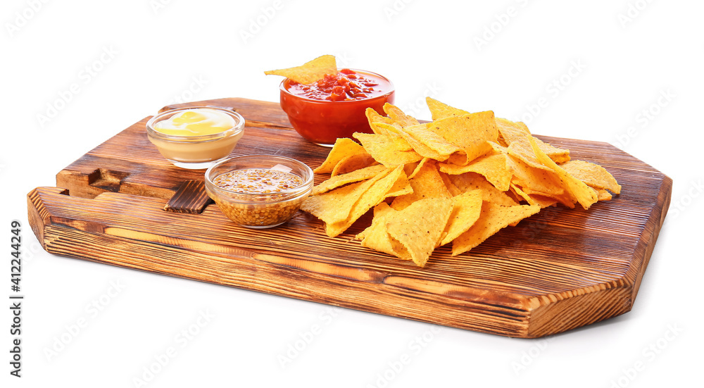 Board with tasty nachos and sauces on white background