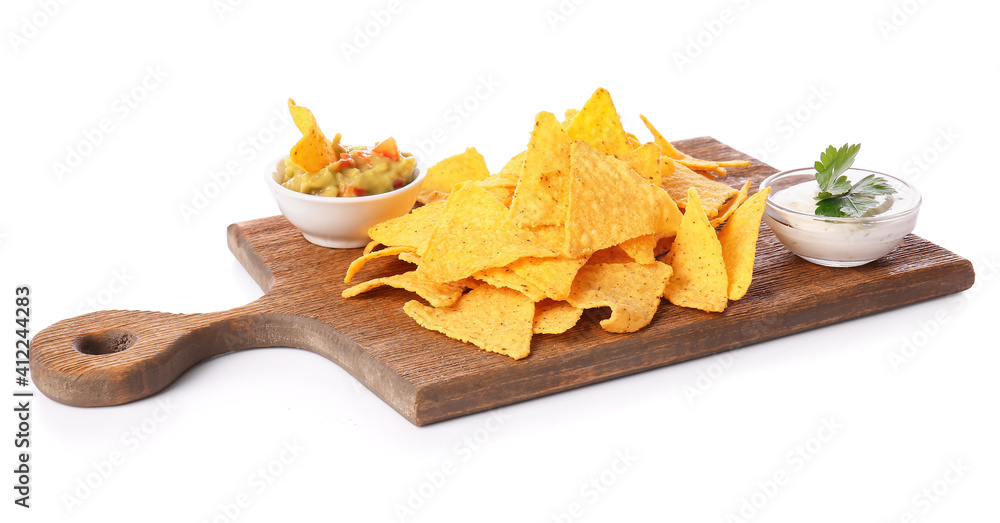 Board with tasty nachos and sauces on white background