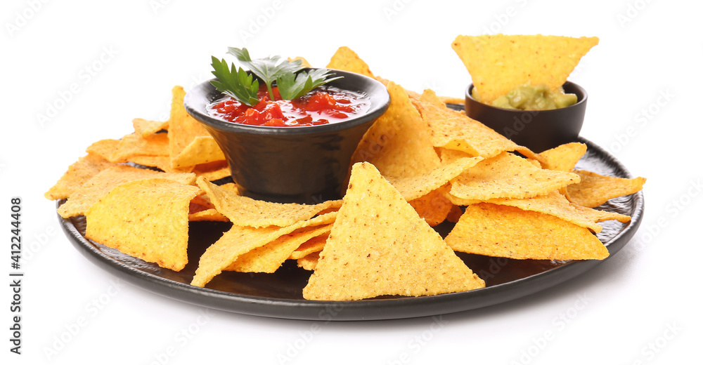 Plate with tasty nachos and sauces on white background