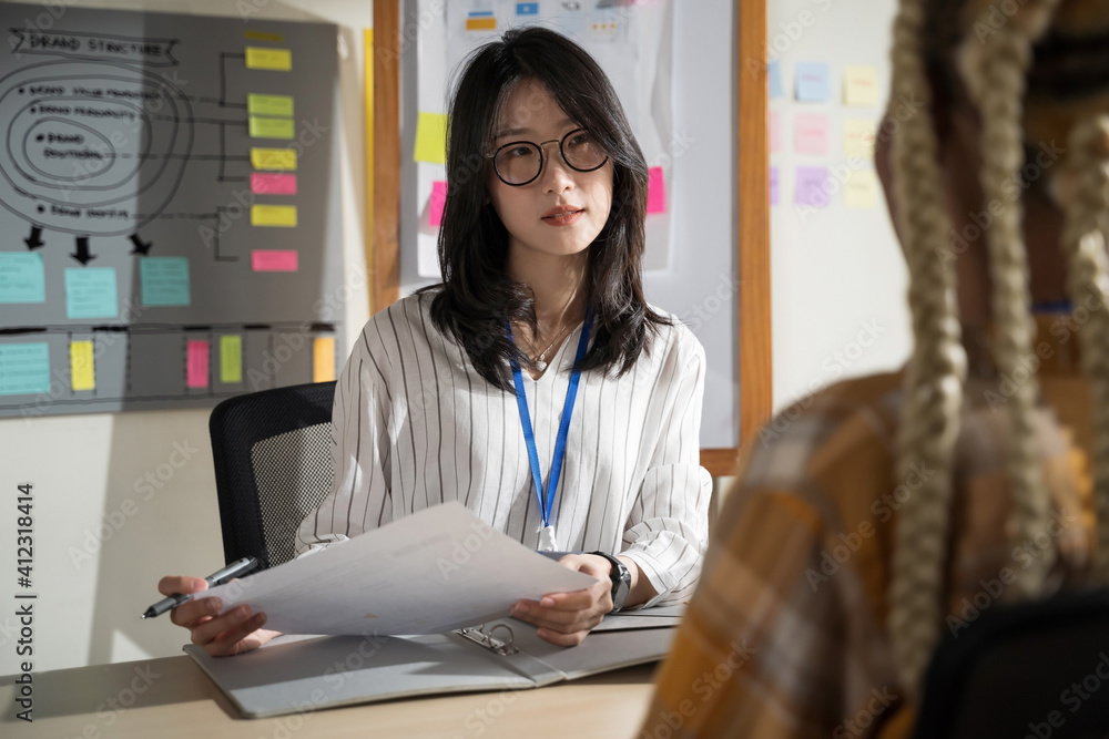 Asian women are doing serious job interviews.