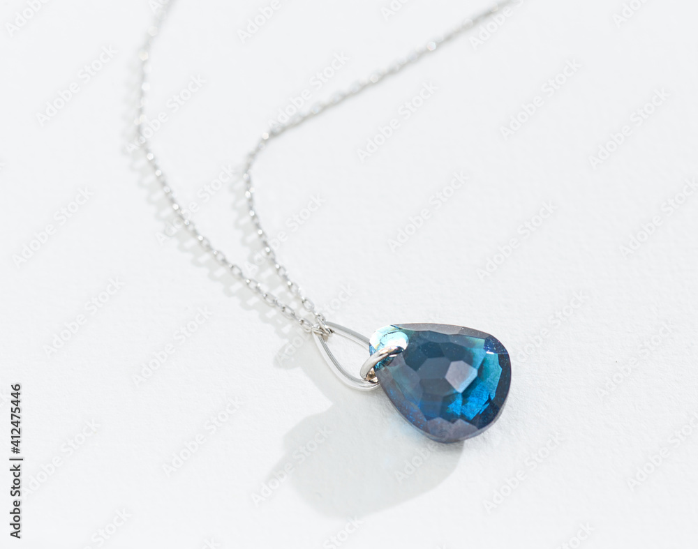 silver chain with blue gemstone