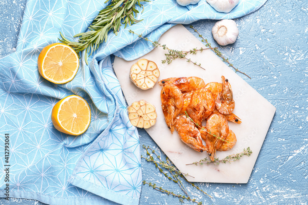 Plate with tasty shrimps on color background