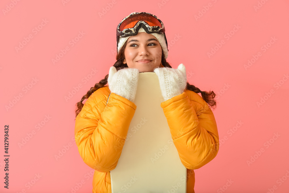 Female snowboarder on color background