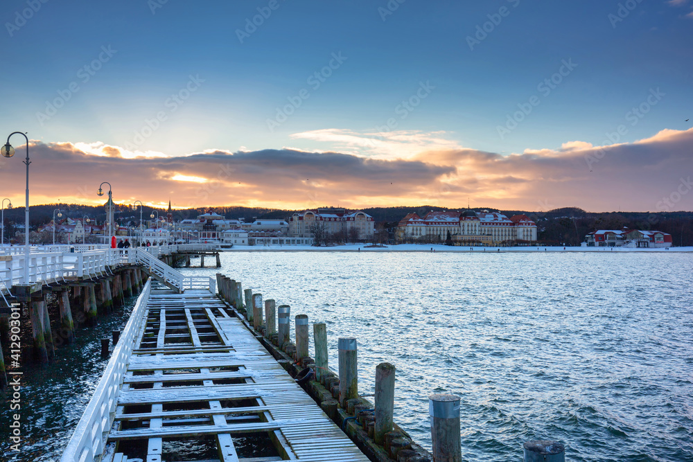 Beautiful sunset over the snowy pier (Molo) in Sopot at winter. Poland