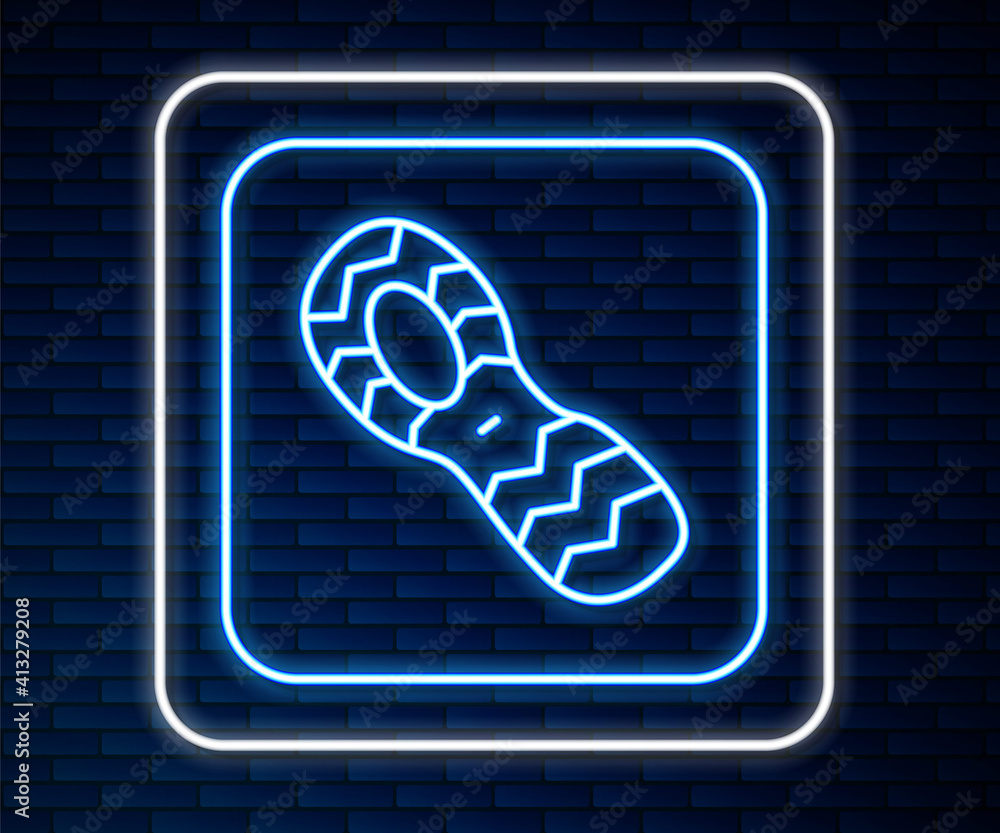 Glowing neon line Human footprints shoes icon isolated on brick wall background. Shoes sole. Vector.