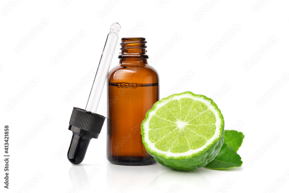 Bergamot essential oil with bergamot fruit cut in half isolated on white background.