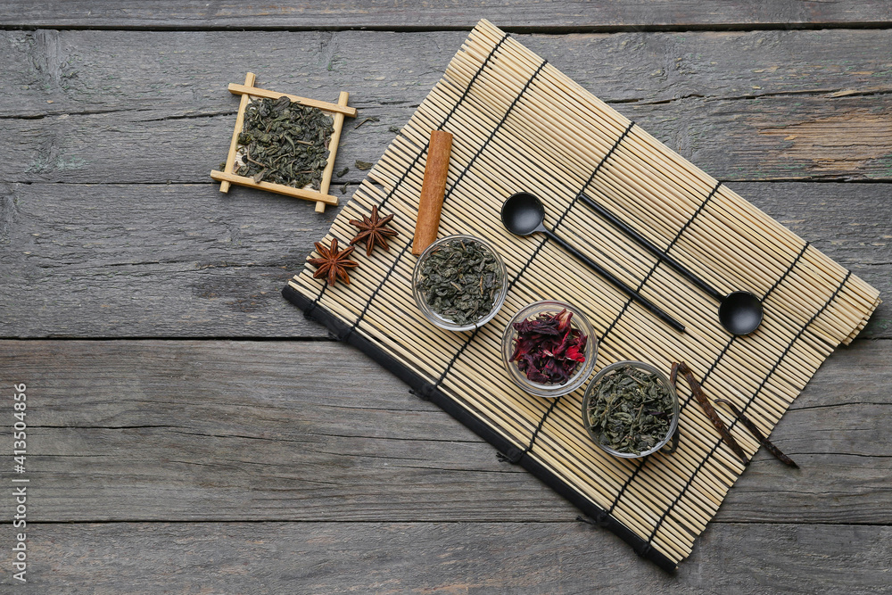 Composition with dry green tea on wooden background