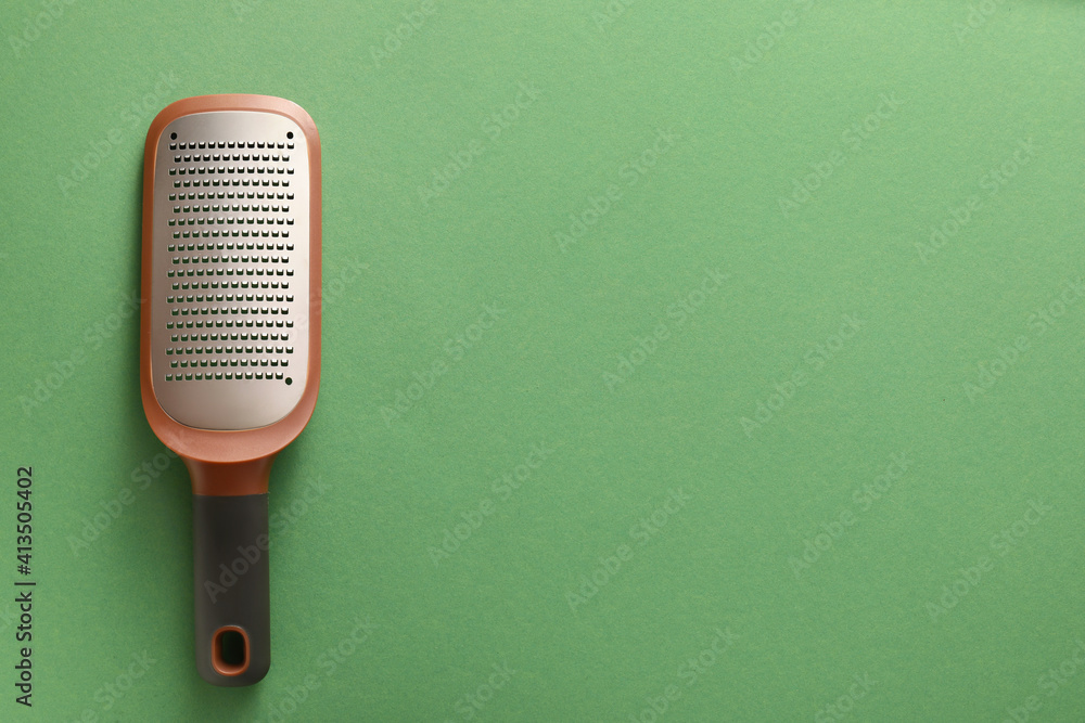 Metal grater on color background