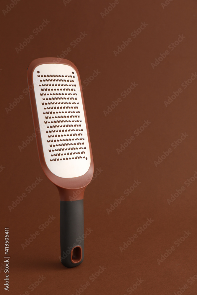 Metal grater on color background