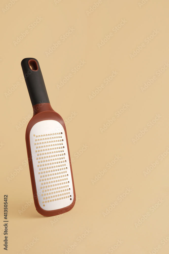 Metal grater on color background