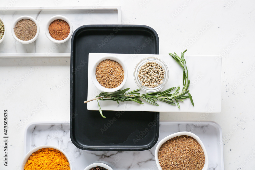 Bowls with different spices on light background