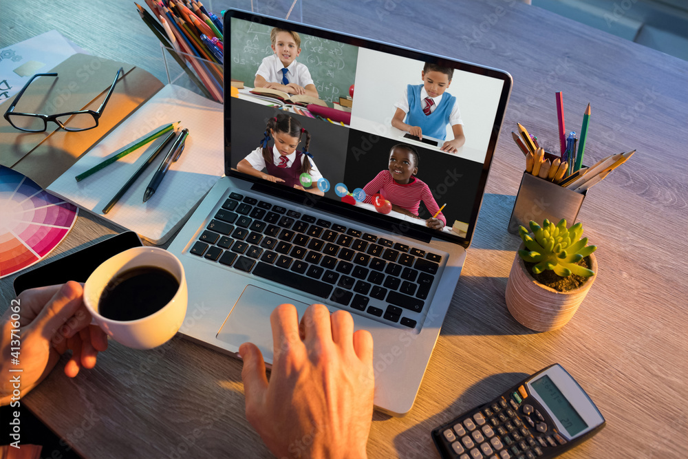 Mid section of teacher having a video conference with multiple students on laptop at school