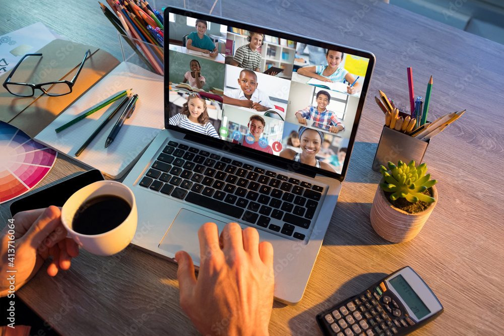 Mid section of teacher having a video conference with multiple students on laptop at school