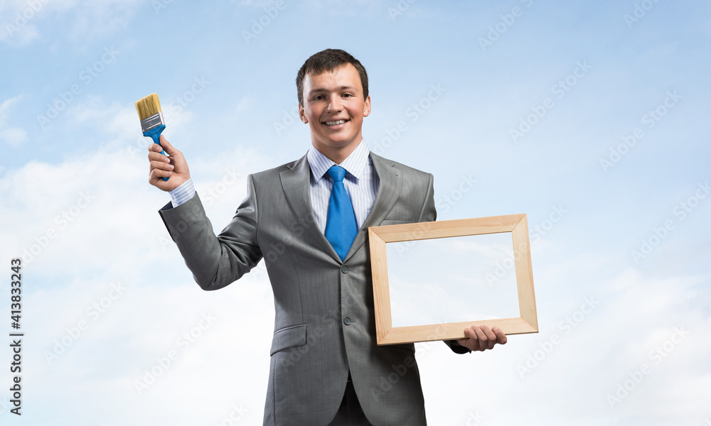 Creative businessman painter holding paintbrush