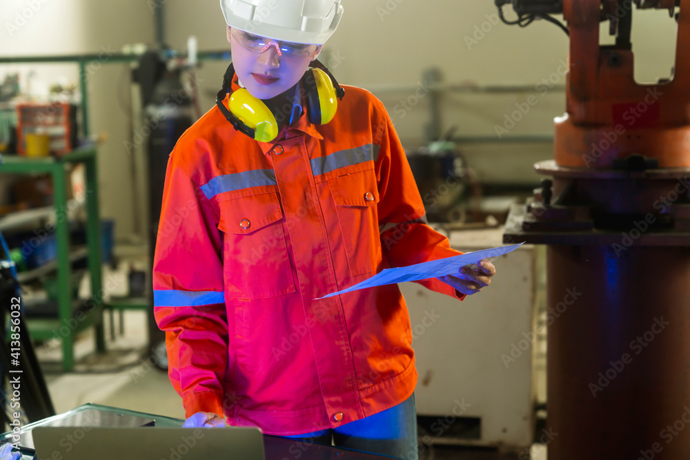 asian female engineer specialist with Measuring machine with a manipulator arm laptop.Three-dimensio