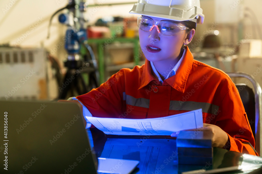 asian female engineer specialist with Measuring machine with a manipulator arm laptop.Three-dimensio