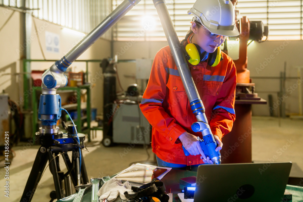 asian female engineer specialist with Measuring machine with a manipulator arm.Three-dimensional coo