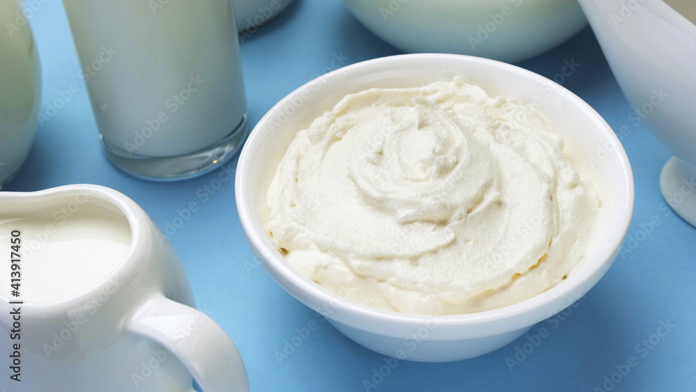 Whipped cream on blue background, top view