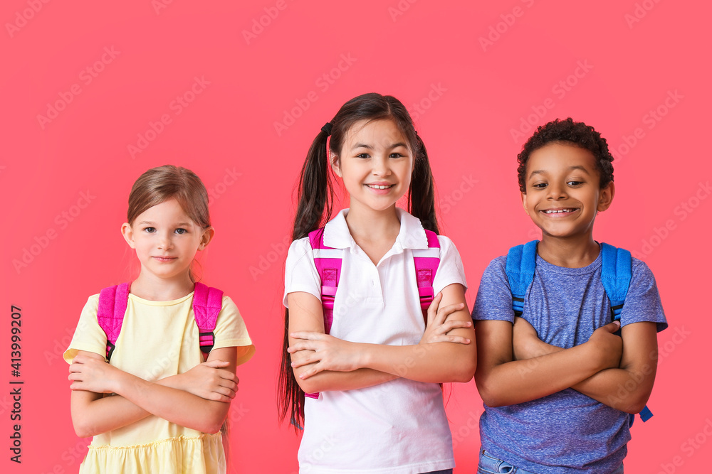 Little schoolchildren on color background