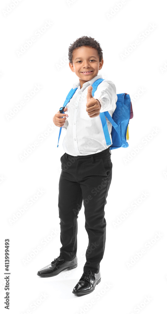 Little African-American schoolboy showing thumb-up gesture on white background