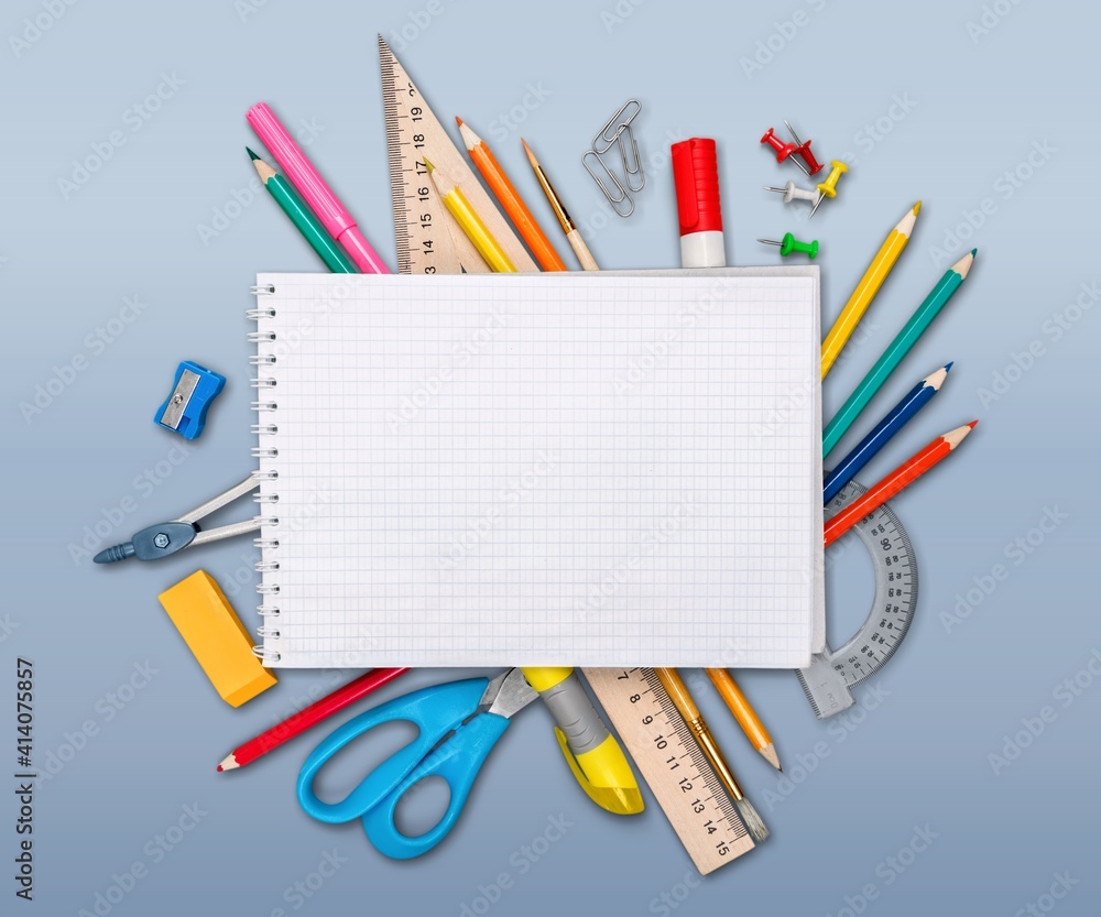 Colorful school supplies on wooden table background