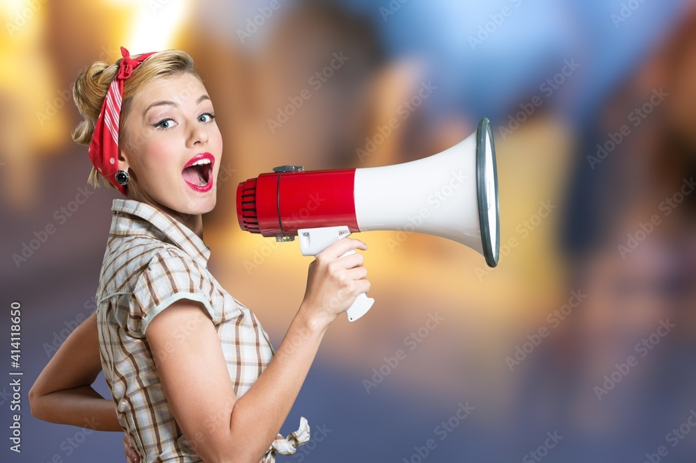 Beautiful woman holding megaphone and screams