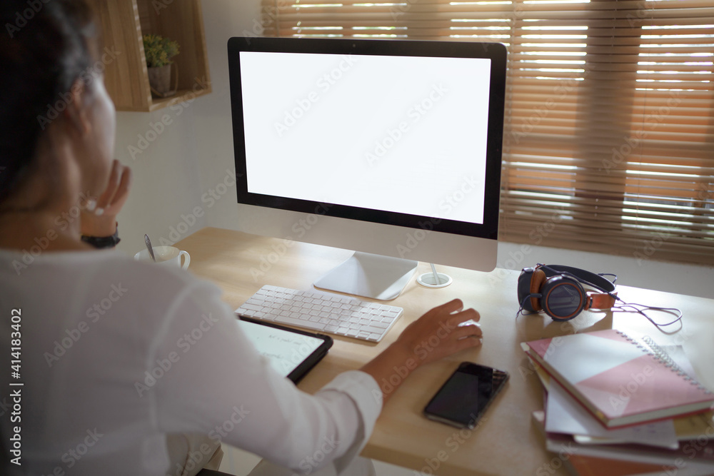 Asian woman She works at the home desk. White open space in the screen