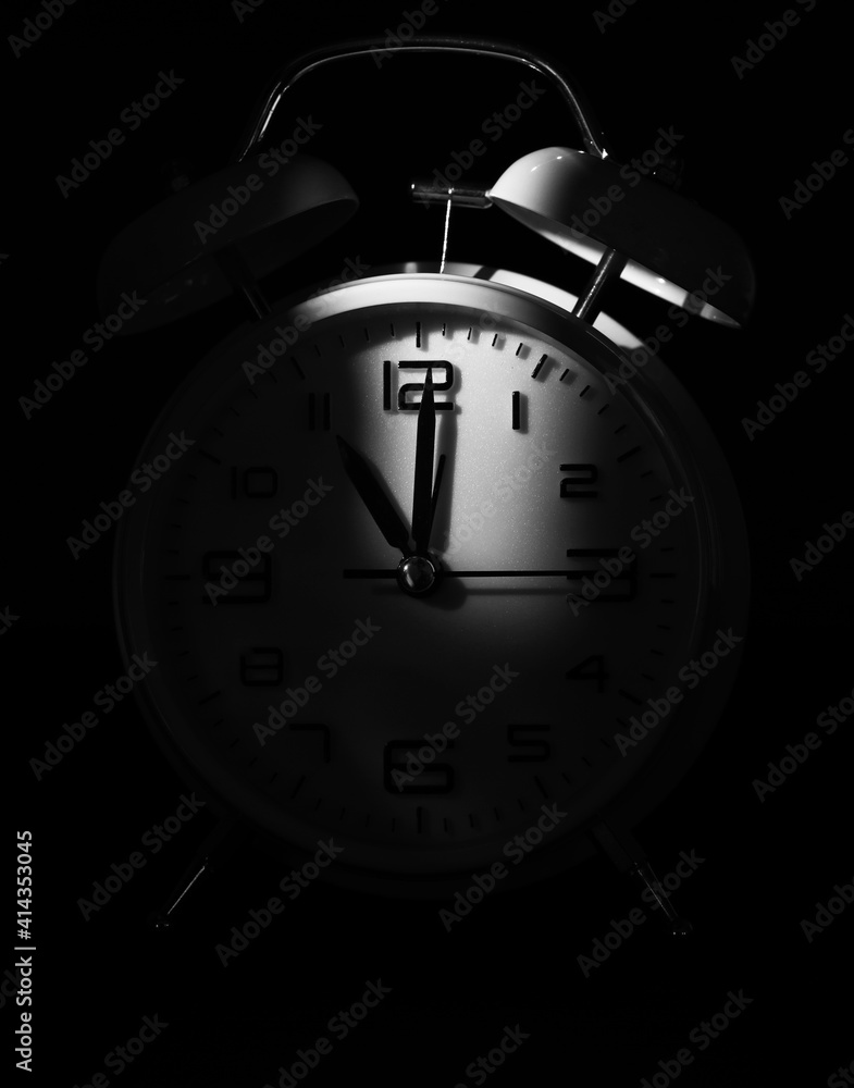 Alarm clock on black background, closeup