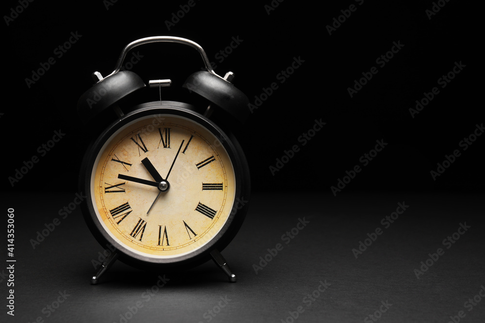 Alarm clock on black background