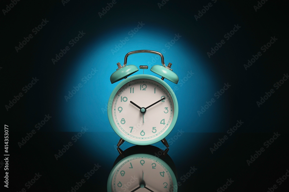 Alarm clock on black background