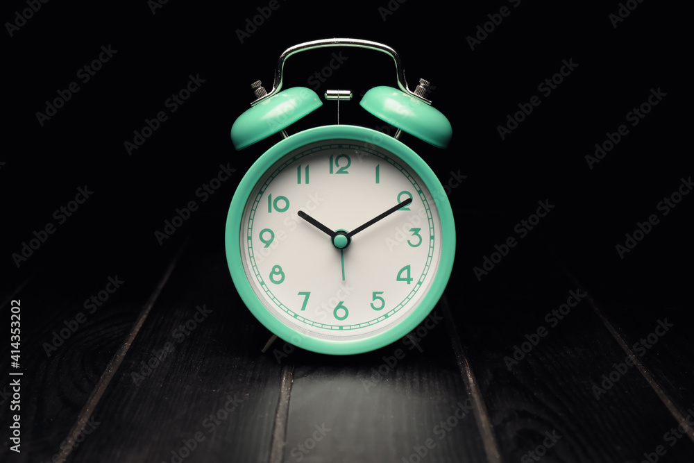 Alarm clock on black background