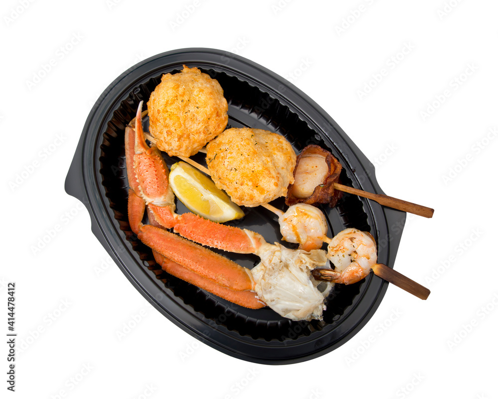 dish of seafood including crab leg, scallop, shrimpand crab cake