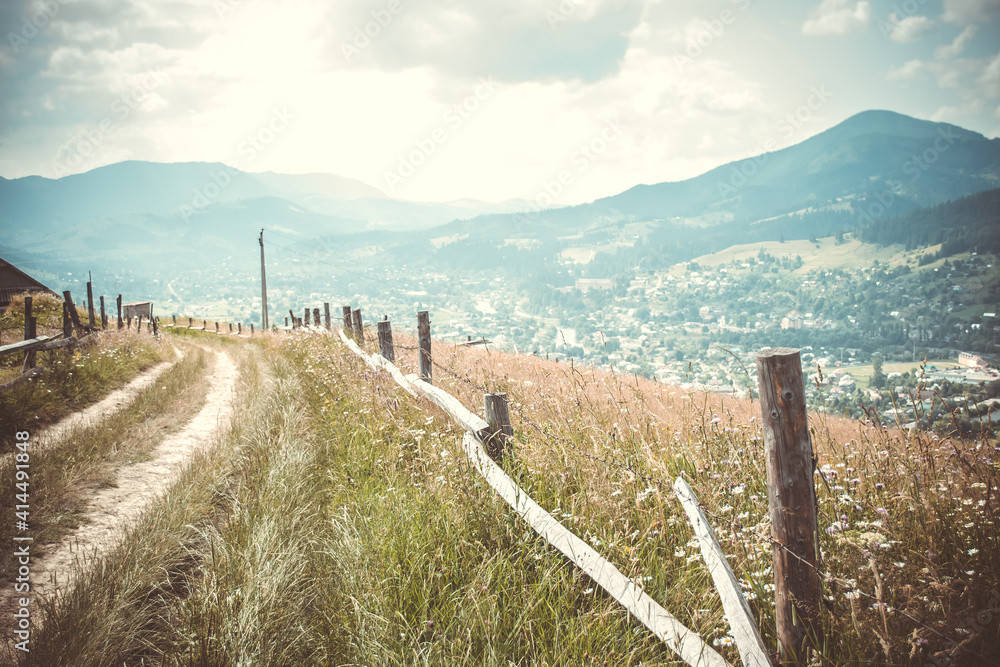 dirt road on a background of mountains