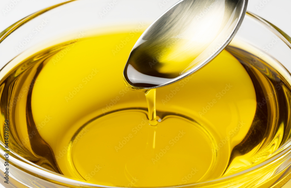 Olive oil in a bowl placed on a white background