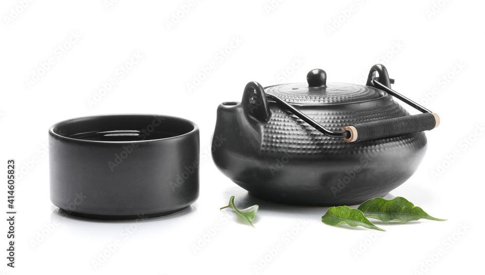 Stylish teapot and cup of tea on white background