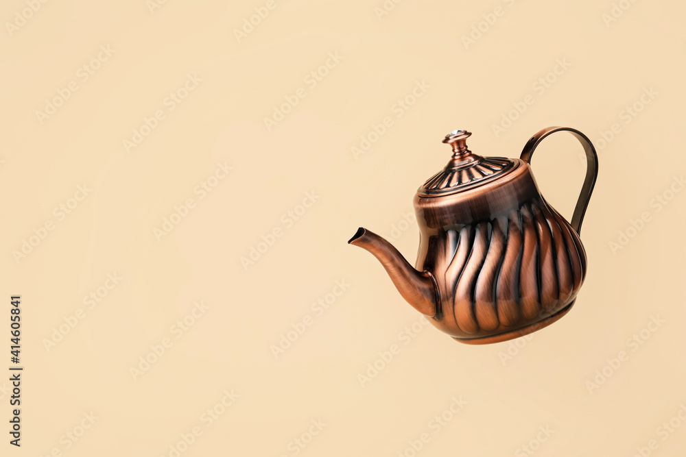 Stylish teapot on color background