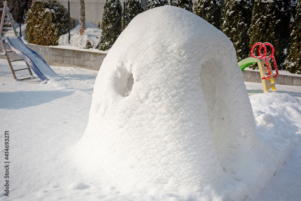 Beautiful winter garden with snow igloo at sunny day. Poland