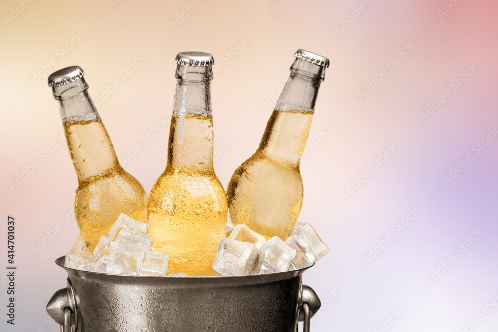 Bottles of cold and fresh beer with ice in the bucket