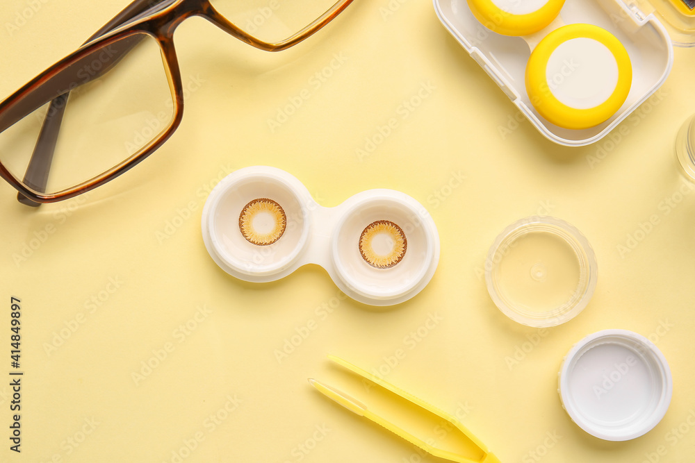 Composition with contact lenses and accessories on color background