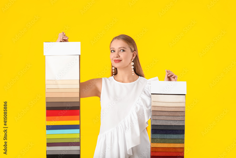 Female interior designer on color background