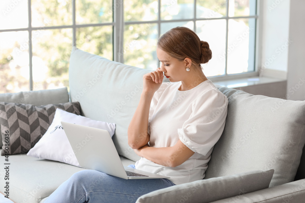 Stressed young woman asking psychologist for advice online at home